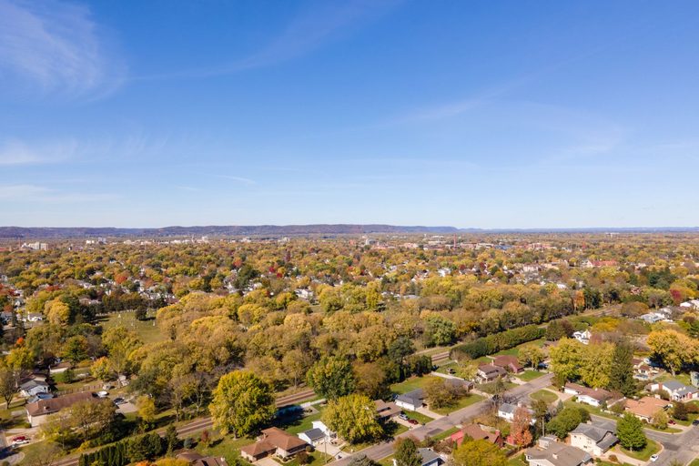 Aerial view of a flat, tree lined suburban neighborhood